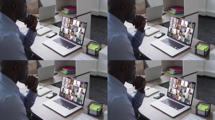 非裔美国人高级男子在办公室的笔记本电脑上与同事进行视频会议
