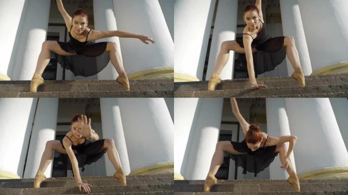 微笑苗条芭蕾舞演员模仿城市楼梯上的蜘蛛的表演。积极的年轻白人妇女的肖像tip着脚尖跳芭蕾舞。艺术表演