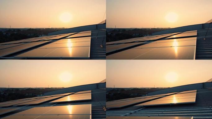 日落屋顶上的太阳能电池板农场