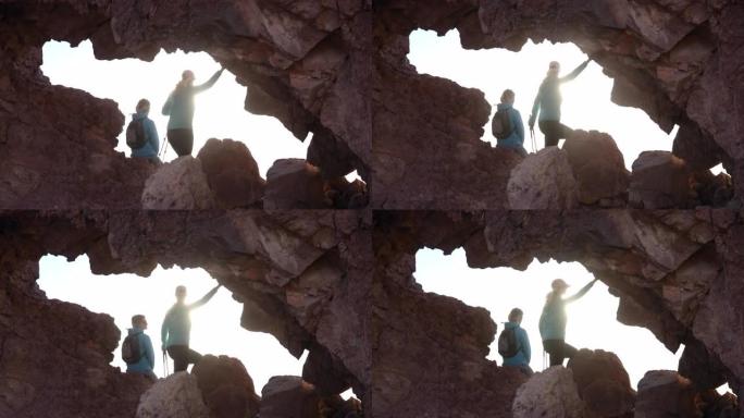 女徒步旅行者探索沙漠天然岩石拱门