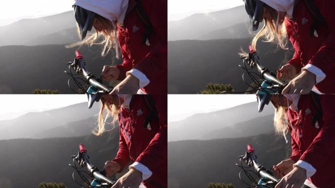 女山地自行车手在岩石山顶进行修理