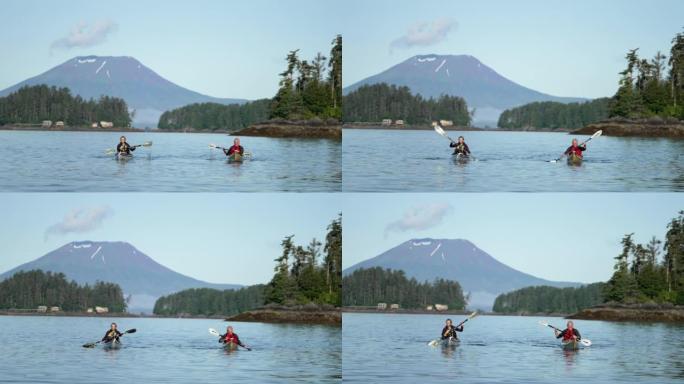 两名年长的皮划艇运动员在火山后面的河上划桨
