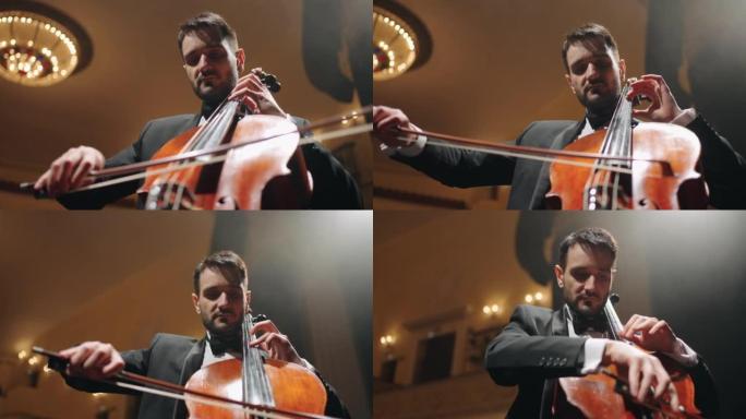 受启发的男音乐家正在老歌剧院的现场演奏大提琴，音乐厅的大提琴手肖像