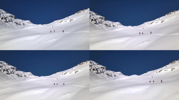 空中无人机在积雪覆盖的山上对徒步旅行者进行了广泛射击