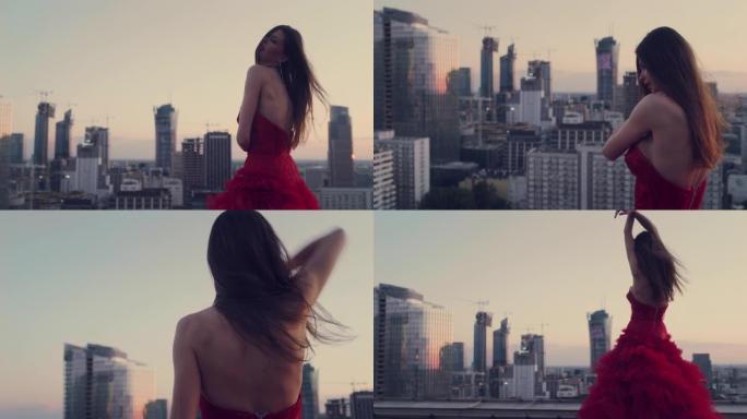 屋顶上诱人的女人。穿着红色漂亮的连衣裙。用相机调情