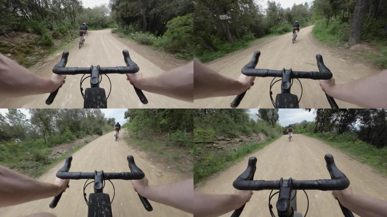 POV在穿过西班牙森林的砾石道路上骑砾石自行车