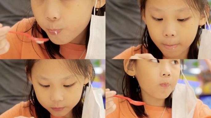亚洲女孩在周末与家人一起在美食广场吃冰淇淋，生活方式。
