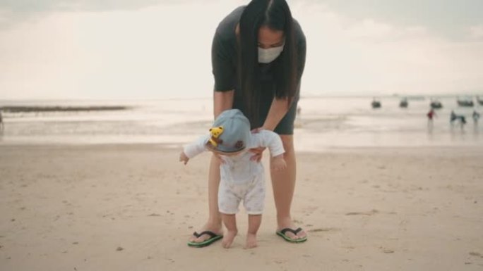 Mother and son enjoying summer beach together.