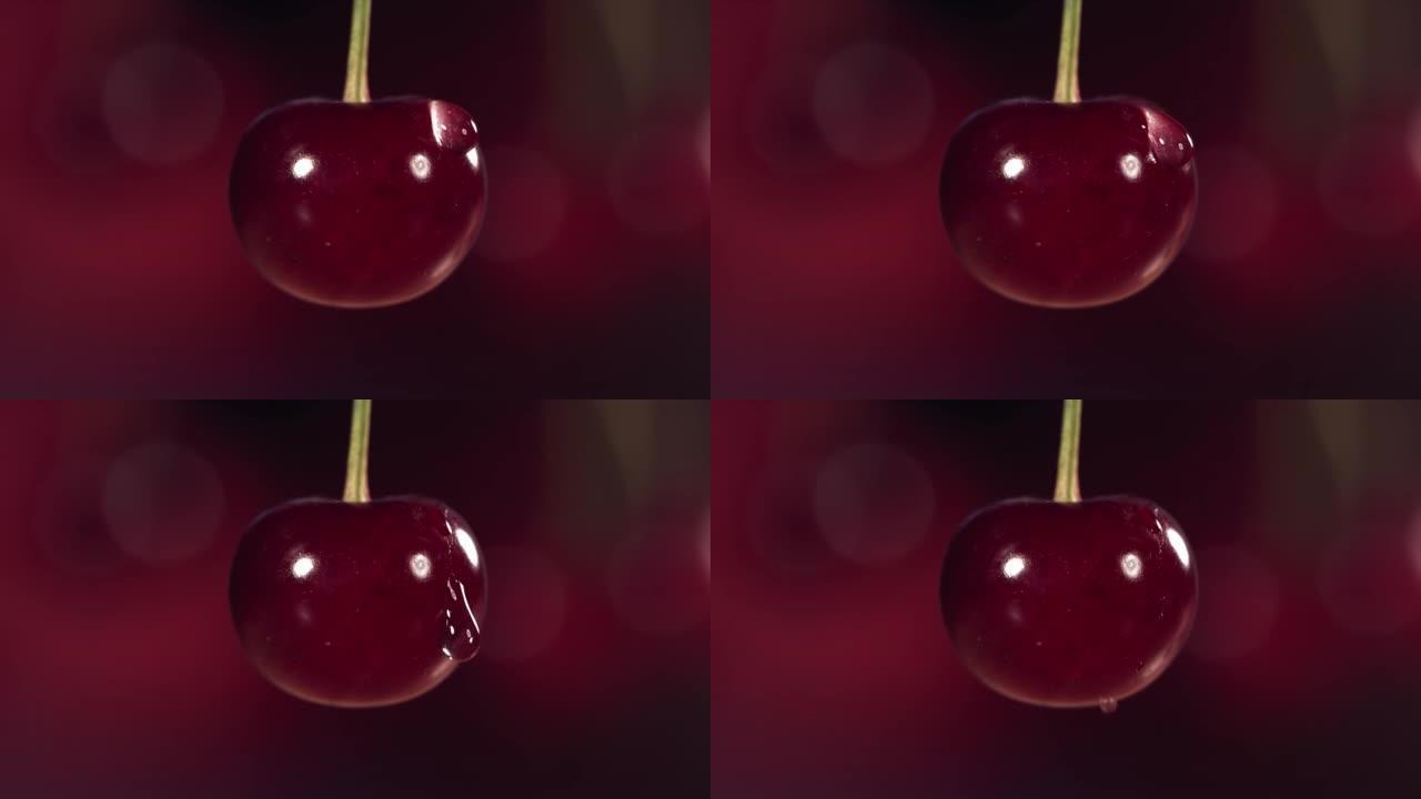 水滴从深红色背景的新鲜樱桃中落下，慢动作