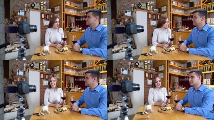 年轻夫妇为他们的追随者拍摄了一段关于不同种类葡萄酒的视频