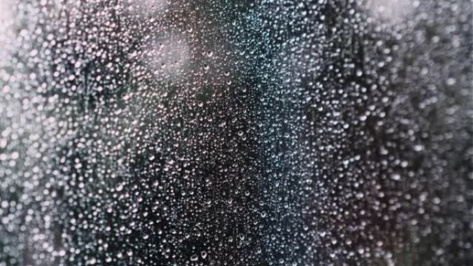 带雨滴的湿窗玻璃特写。