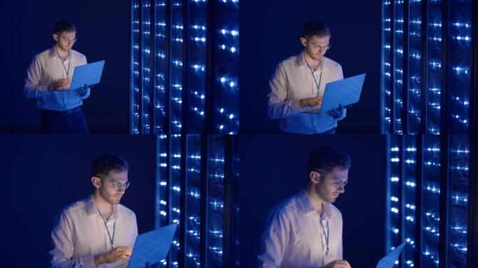 男性网络工程师用笔记本电脑站在服务器机房进行系统检查。在数据中心，男性服务器专家检查机架式服务器计算