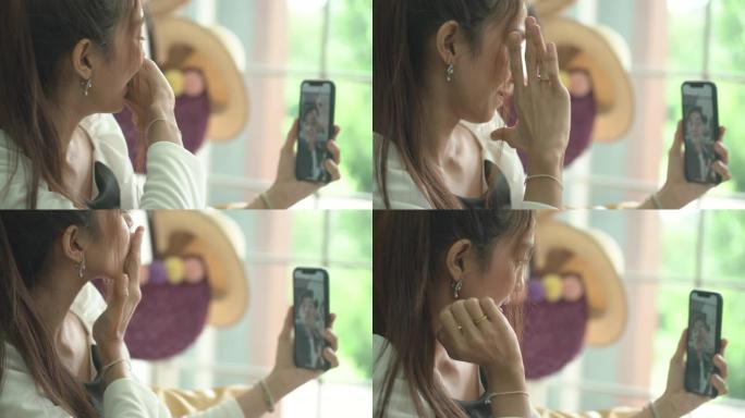 女人在视频通话中向手机屏幕发送air kiss