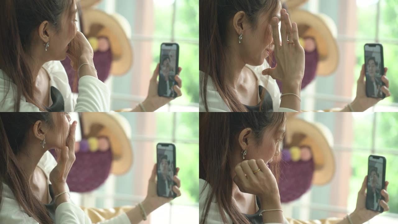 女人在视频通话中向手机屏幕发送air kiss