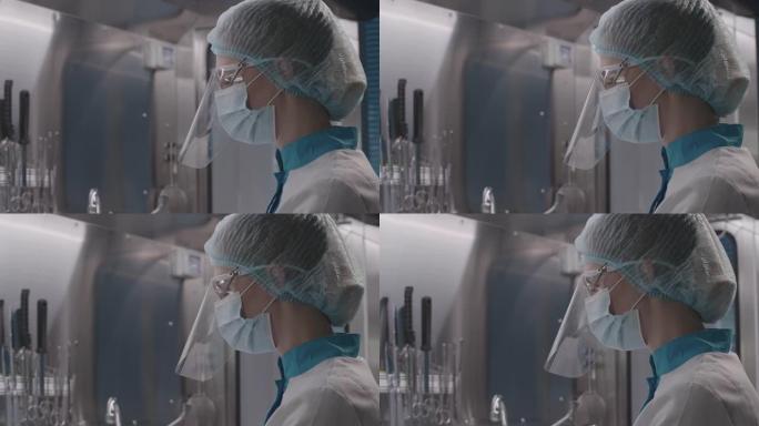 穿着防护服和口罩的女医务人员准备手术，移植或植入，在无菌环境中研究生物样品，慢动作