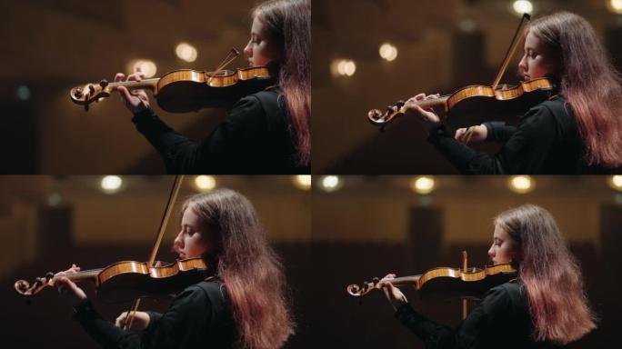 交响乐团的第一小提琴，年轻女子在音乐厅，肖像现场拉小提琴