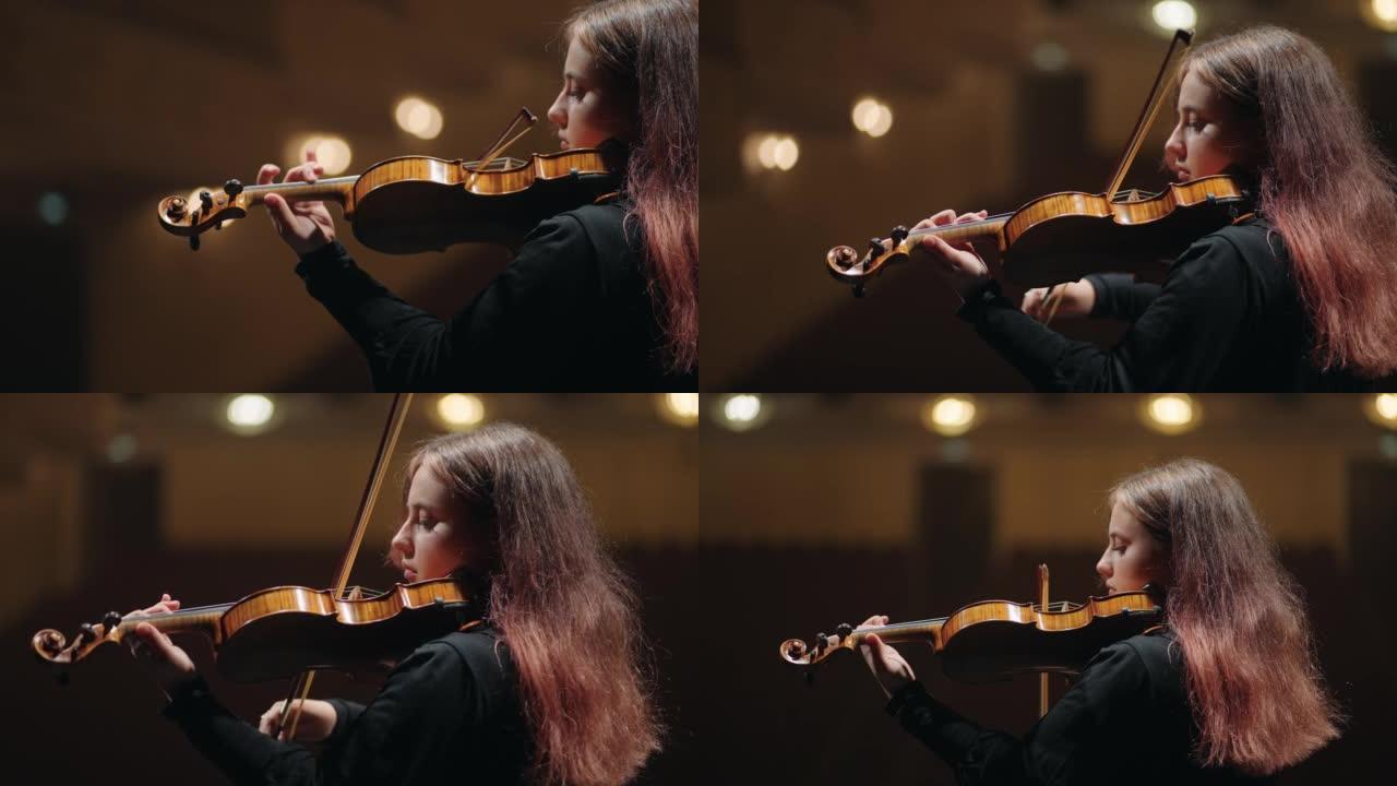 交响乐团的第一小提琴，年轻女子在音乐厅，肖像现场拉小提琴