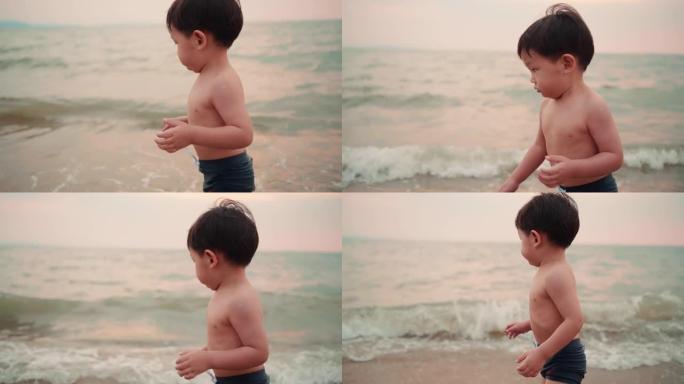 慢动作: 亚洲男婴在沙滩上享受和玩耍