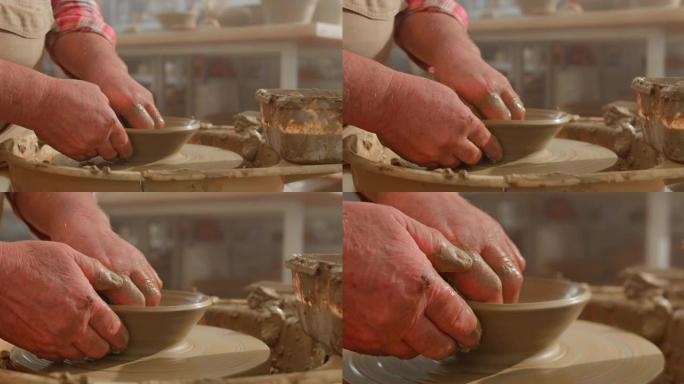 DS男陶工的手在陶工的轮子上制造了一个锅