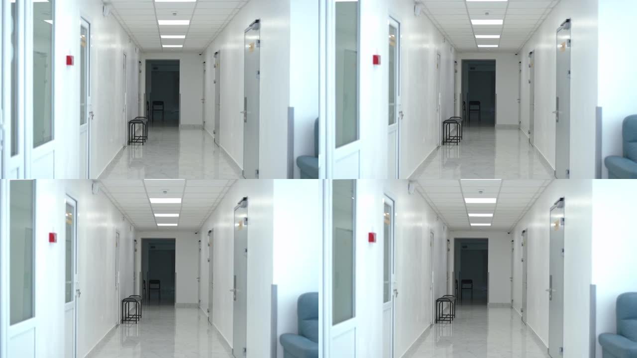 空荡荡的医院走廊，室内没有人。宽镜头白色清洁现代医疗诊所，里面没有人。服务和医疗保健的概念。