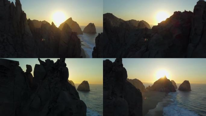 空中无人机在日出时拍摄的岩石悬崖边海滩