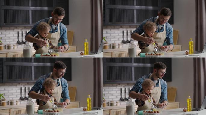 男人和小男孩正在为煎蛋卷打鸡蛋，父亲正在学习儿子在家庭厨房做饭，一起度过时光