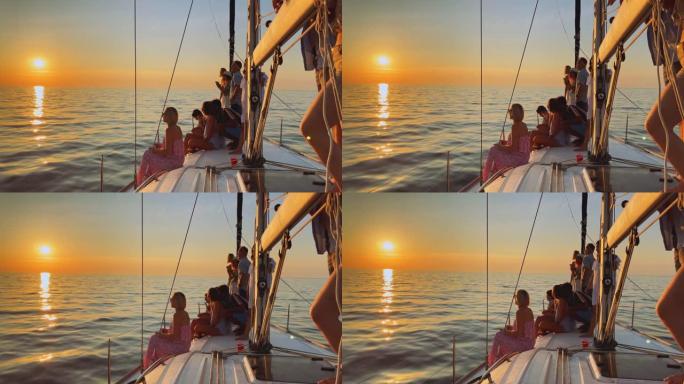 游艇上的SLO MO LD人们享受着夕阳西下的大海