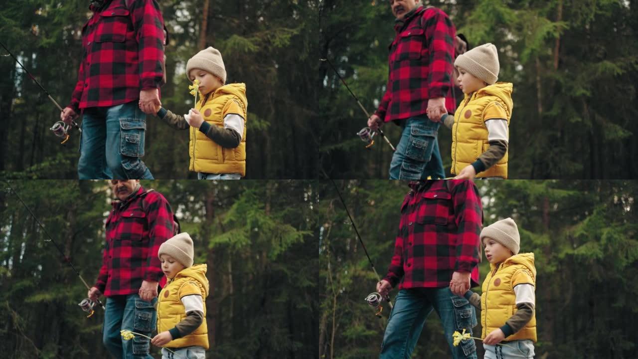 快乐的小男孩和他的父亲或爷爷在春天或秋天在大自然中行走