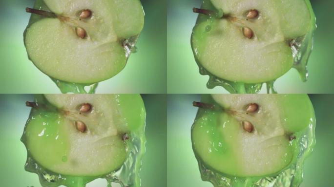 来自半个苹果的流动青苹果汁，慢动作拍摄