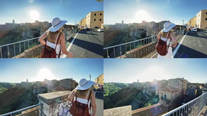 在意大利享受暑假的旅游妇女: 在典型的小镇上散步