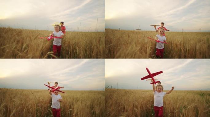 快乐的孩子们在金色的麦田里奔跑和玩耍，男孩们背着玩具飞机，微笑的孩子们的脸