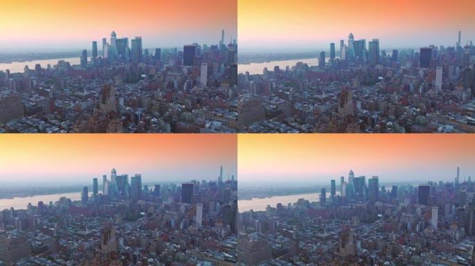 在纽约高楼林立的城市景观上拔地而起。在粉色天空的映衬下，令人印象深刻的优秀大都会建筑。