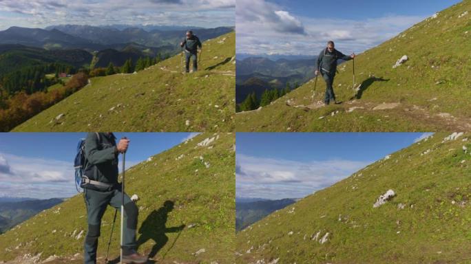 高级男性徒步旅行者在阳光下的风景优美的小径上爬山