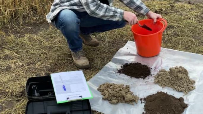 农学家整理土壤样本，在户外做笔记