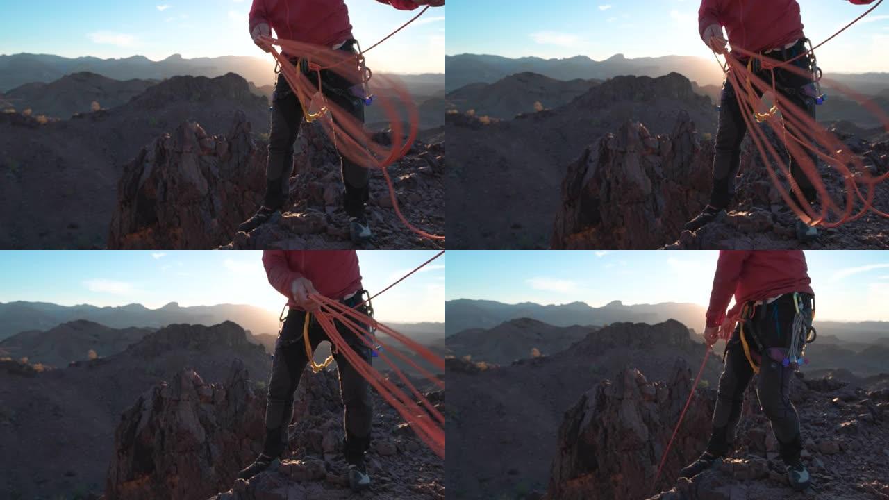 登山者准备在山顶上下降的绳索