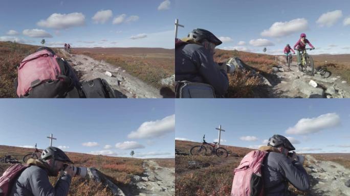 摄影师拍摄了一对山地自行车夫妇在广阔的土地上骑行