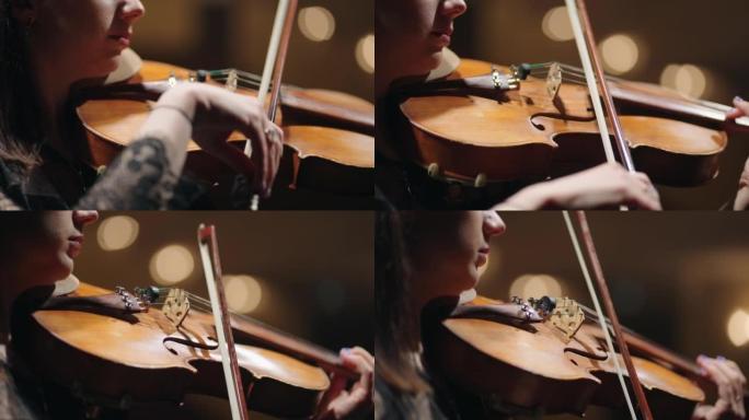 女小提琴手在音乐学校拉小提琴，女人手中的小提琴特写