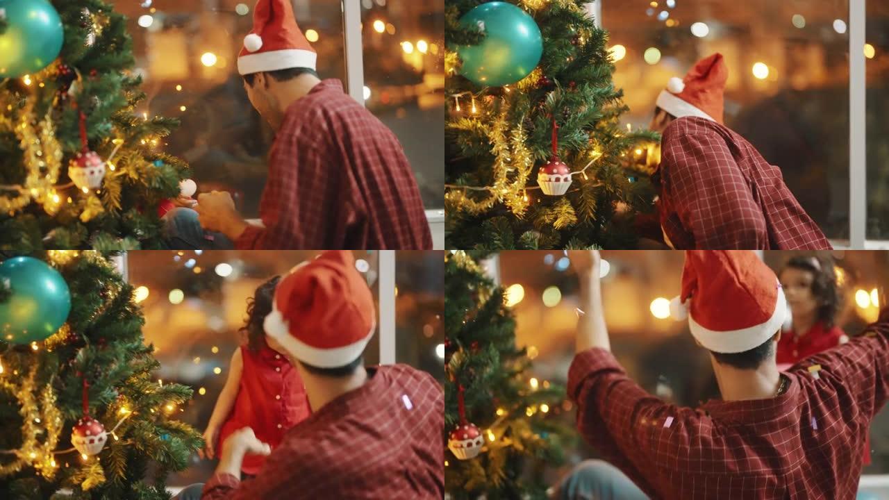 年轻的父亲和戴着红色圣诞老人帽子的小女孩在hometree装饰圣诞节