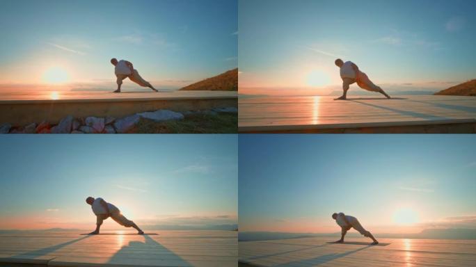 CS男子在夕阳西下的山上摆瑜伽姿势
