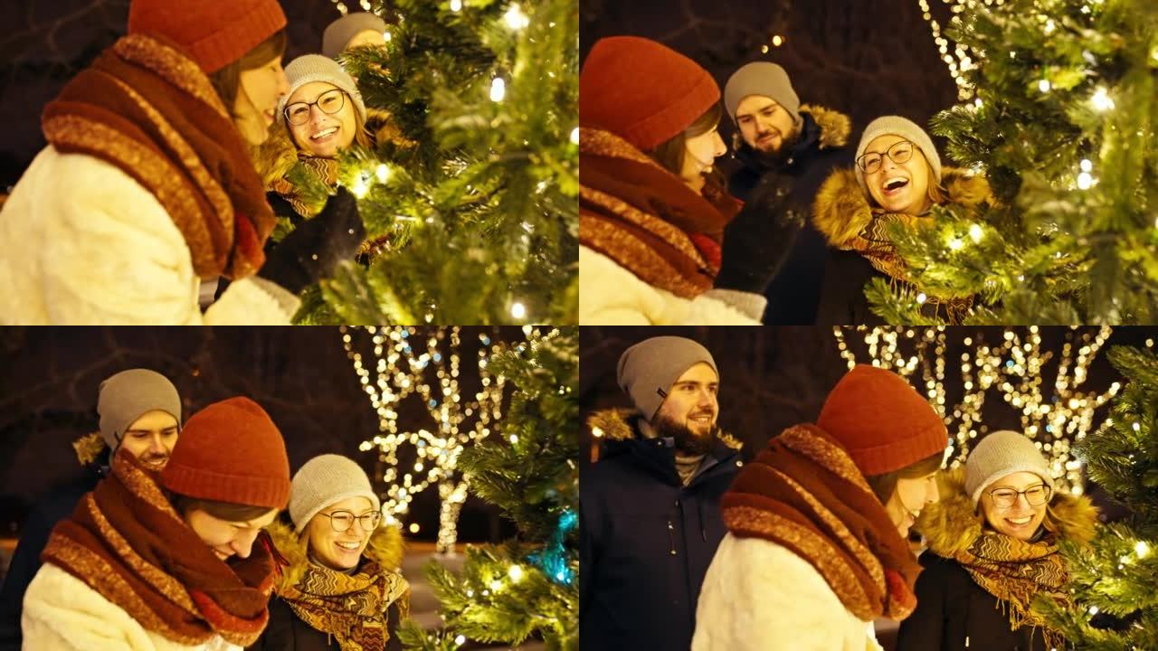 在下雪的夜晚，朋友们一起在慢动作中欣赏圣诞树