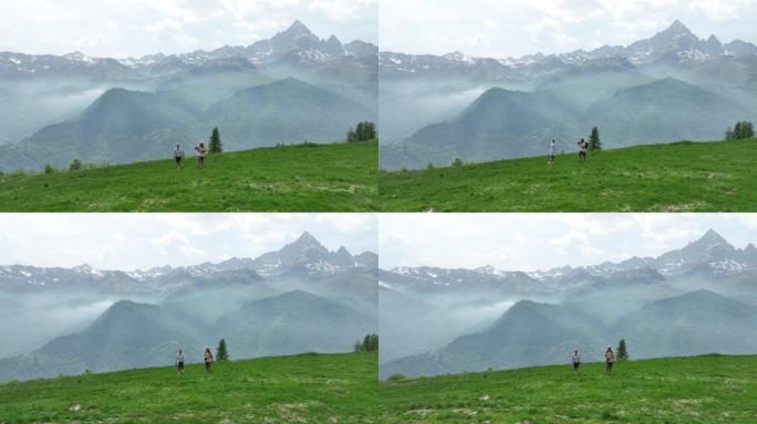 徒步旅行夫妇到达山顶并欣赏山景的鸟瞰图