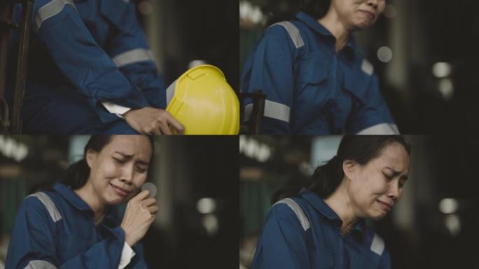โ女工人坐在工厂里为离婚而哭泣。