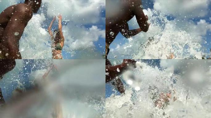 快乐的非洲男人在他女朋友身上泼水。在热带海洋中玩耍