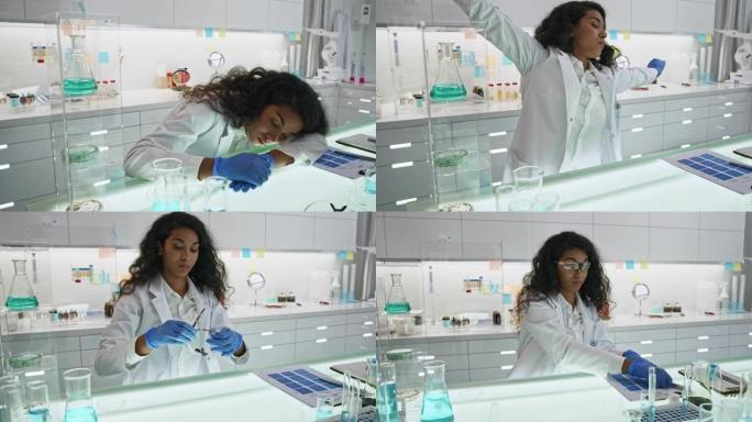 未来主义实验室里筋疲力尽的非洲族裔科学家。睡在桌子上，回去工作