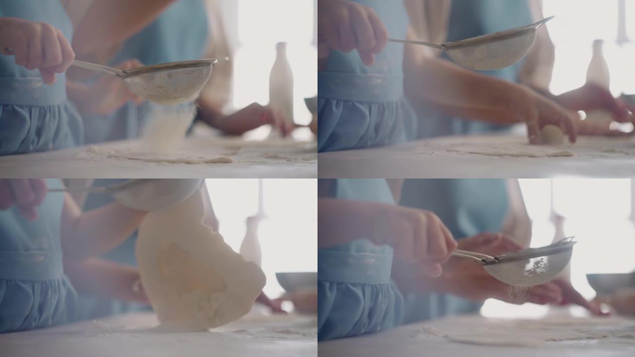小女孩在做馅饼或面包时帮助母亲，女儿在揉面和倒面粉，特写镜头