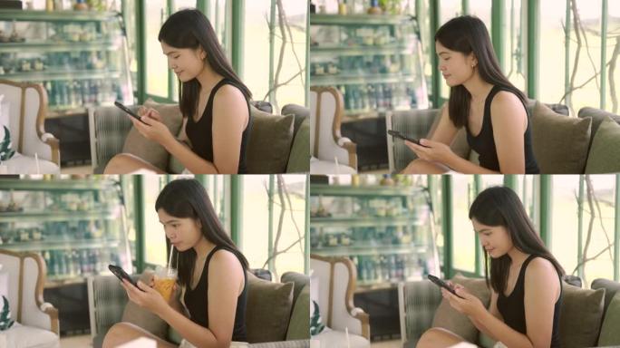 女性喜欢在咖啡馆玩智能手机。