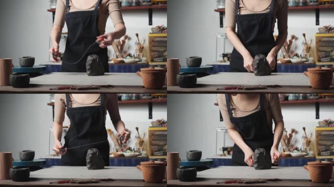 年轻女子在陶器工作室使用用粘土切割的电线。波特女孩用绳子切割粘土。教育、商业、艺术天赋和创意手工制作