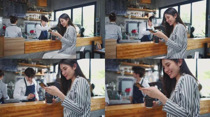 快乐的企业主在咖啡馆使用智能手机