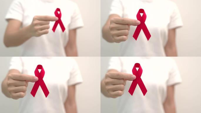 手捧红丝带，12月世界艾滋病日、获得性免疫缺陷综合症、多发性骨髓瘤癌症宣传月和全国红丝带周。医疗保健
