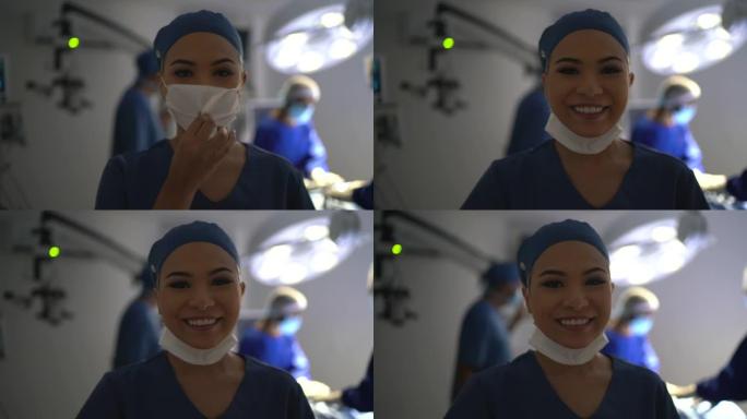 一名年轻的女医护人员脱下口罩并在手术室微笑的肖像
